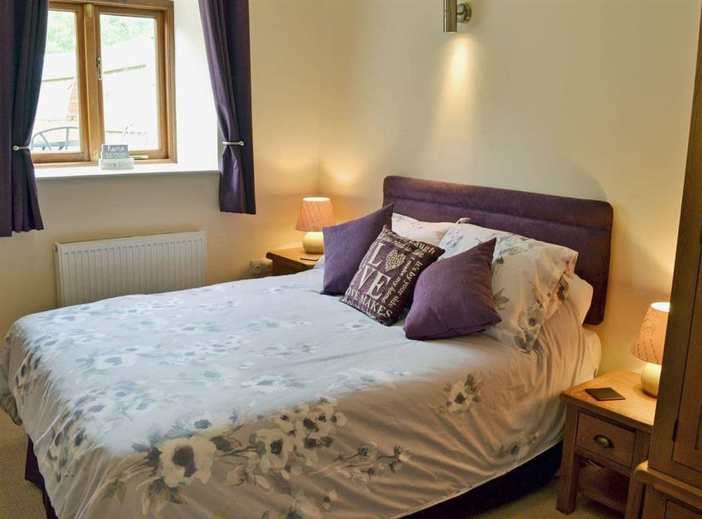 Comfortable bedroom with double bed and single bed at Blackthorn Cottage in Swan Pool, near Falmouth, Cornwall