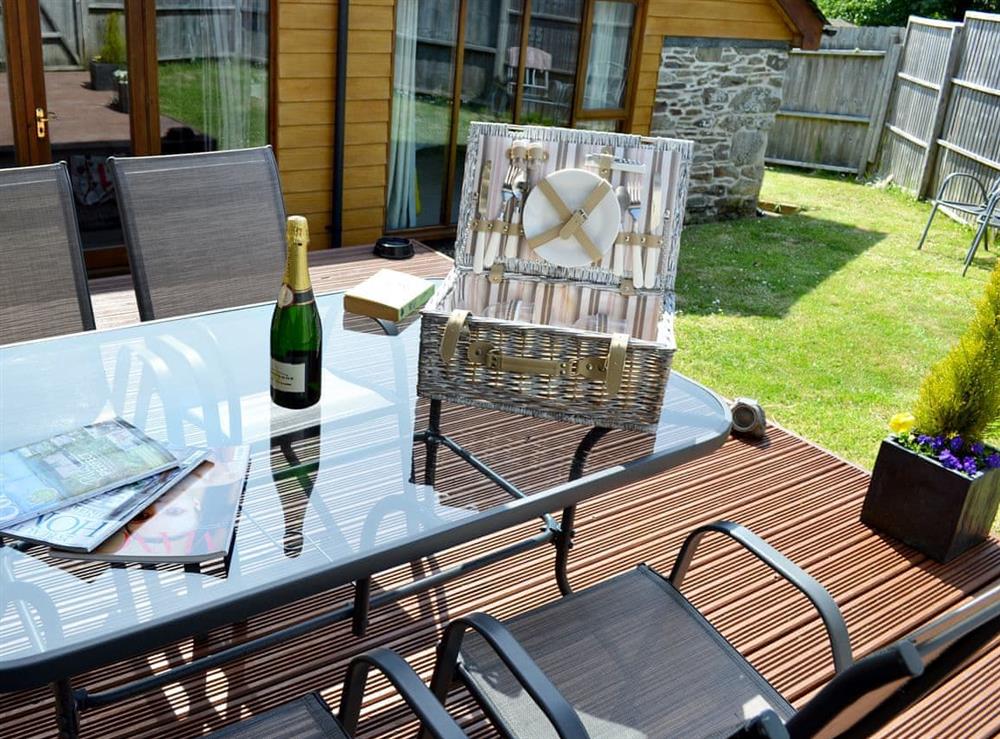 Inviting decking with relaxing sitting-out-area at Blackthorn Cottage in Swan Pool, near Falmouth, Cornwall