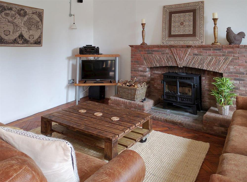 Lovely open plan living area with feature fireplace at Cherry Cottage, 