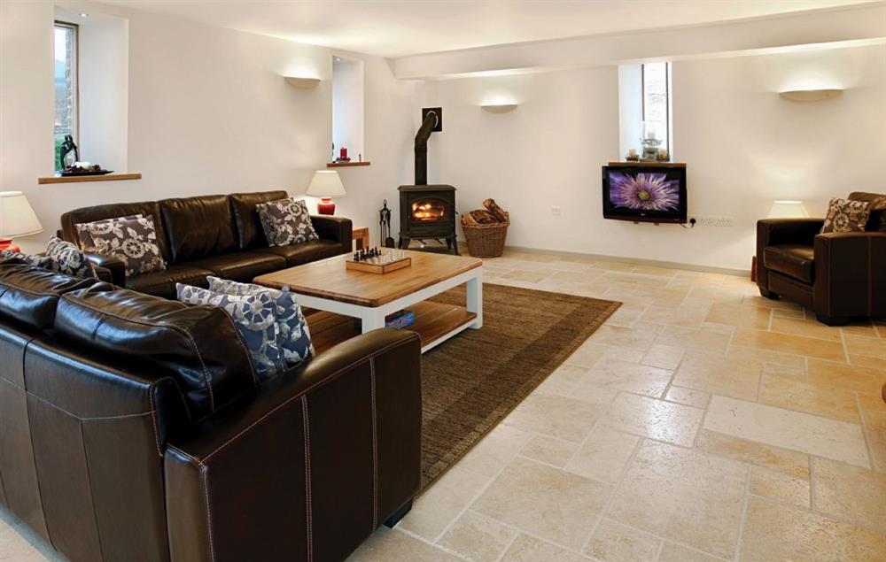 Open plan sitting room with wood burning stove at Blagdon Lower Barn, Martinstown