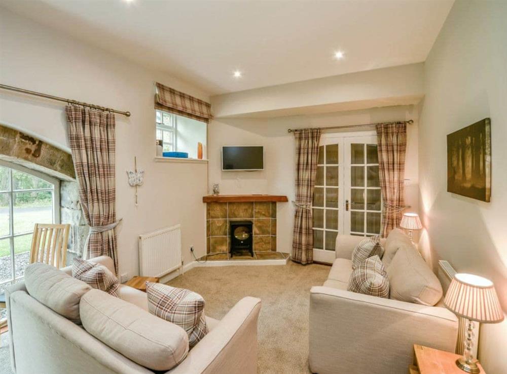 Cosy living room area at Cunninghame Cottage, 