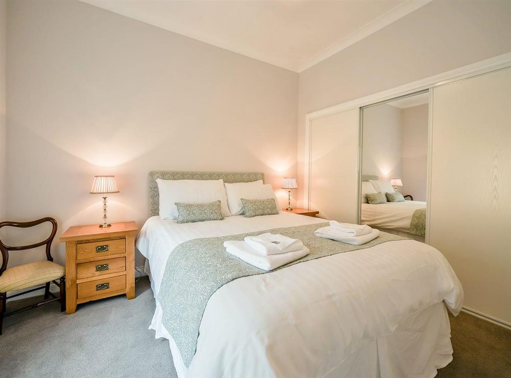 Lovely double bedroom with built-in wardrobes at McKenzie Cottage, 