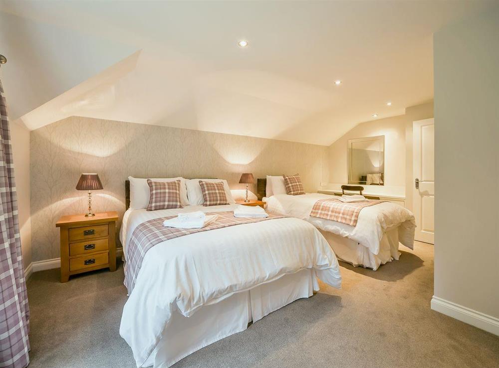 Tastefully decorated double bedroom with single bed for alternative sleeping at McKenzie Cottage, 