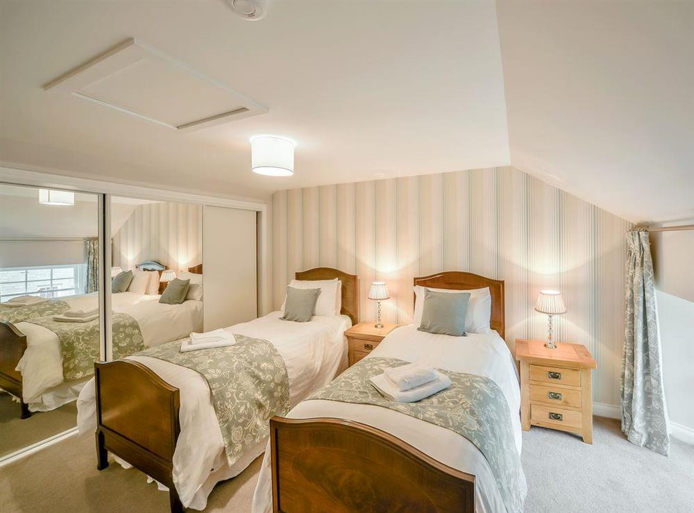 Well presented twin bedroom with built-in wardrobes at McKenzie Cottage, 