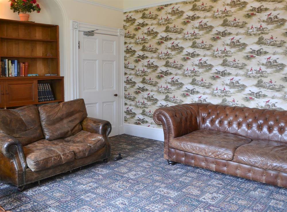 Cosy and welcoming living room with leather sofas at Blaithwaite House, 
