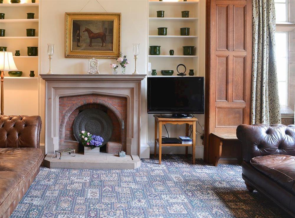 Elegant living room with feature fireplace at Blaithwaite House, 
