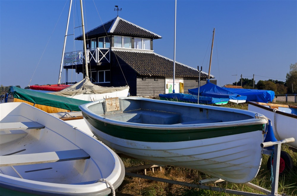 Boats in front of the National Trust Information Centre and observation point at Blakeney Lodge in Blakeney, Norfolk