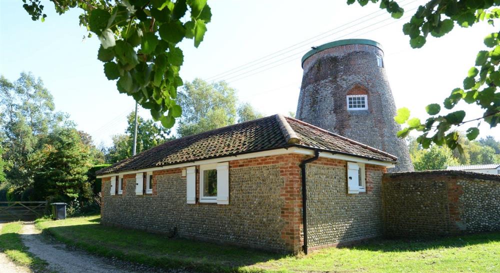 The impressive exterior of Blakeney Lodge and the old windmill, Blakeney, Norfolk at Blakeney Lodge in Blakeney, Norfolk