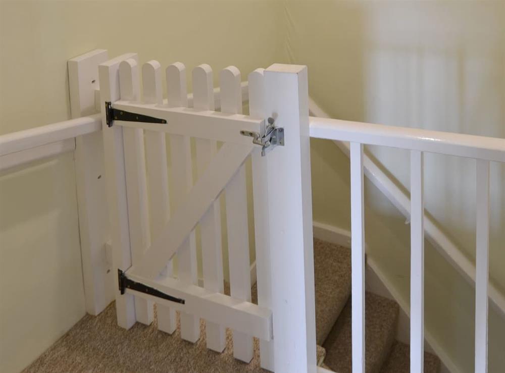 Safety gate at top of stairs at Hollyhock Cottage, 