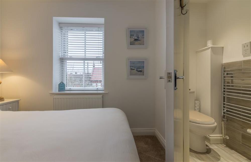 First floor: The master bedroom has an en-suite shower room at Blossom Cottage, Brancaster near Kings Lynn