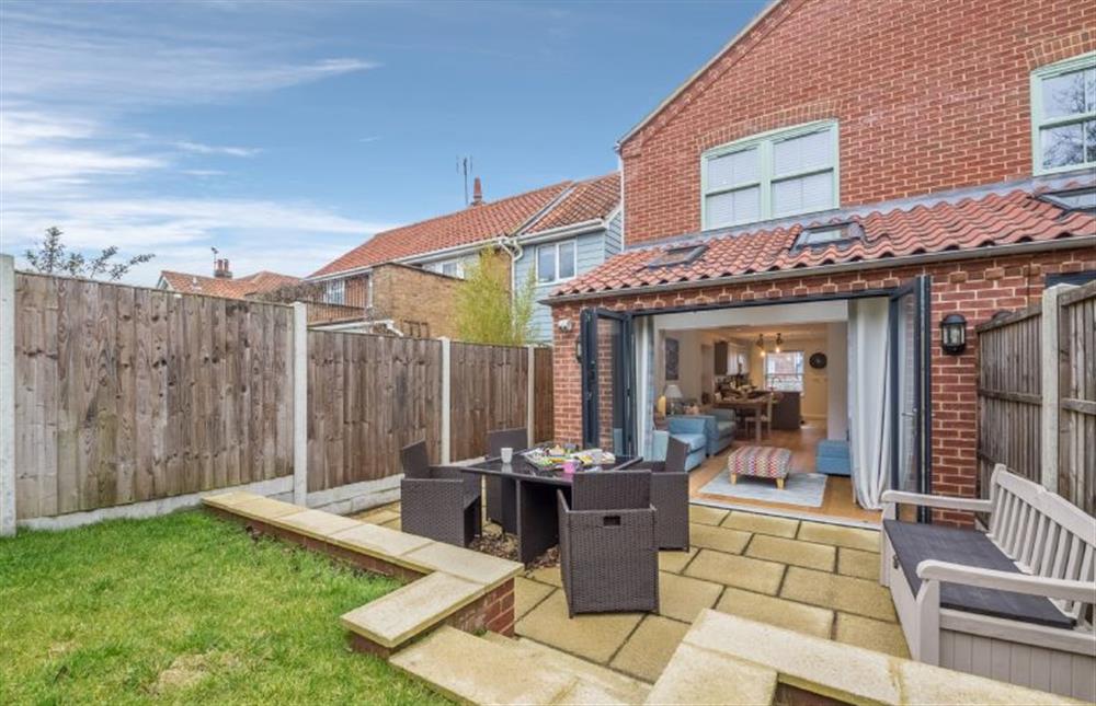 The garden has patio area and raised lawn at Blossom Cottage, Brancaster near Kings Lynn
