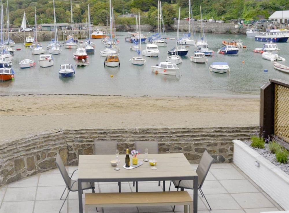 Unique view from living room over the patio area to the picturesque harbour at Blue Beach House in Ilfracombe, Devon