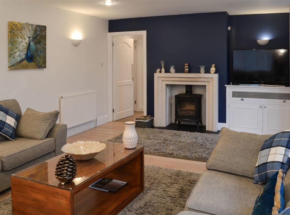 Thoughtfully furnished living room with wood burner at Blue Caps in Beadnell, Northumberland