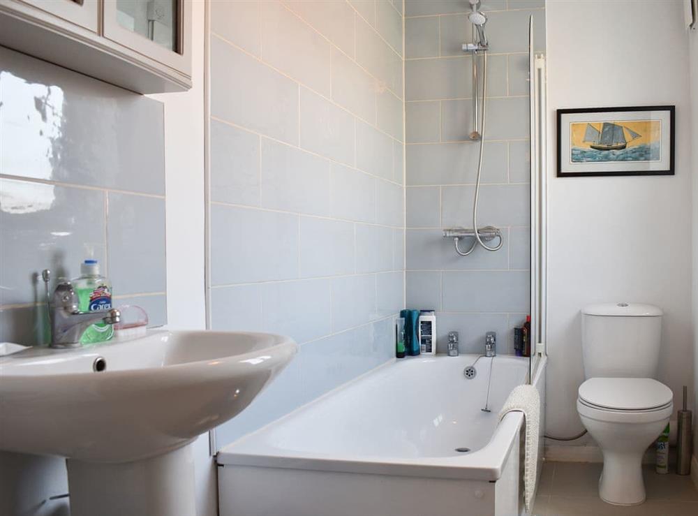 Bathroom with shower over the bath at Blue Cottage in Broadstairs, England