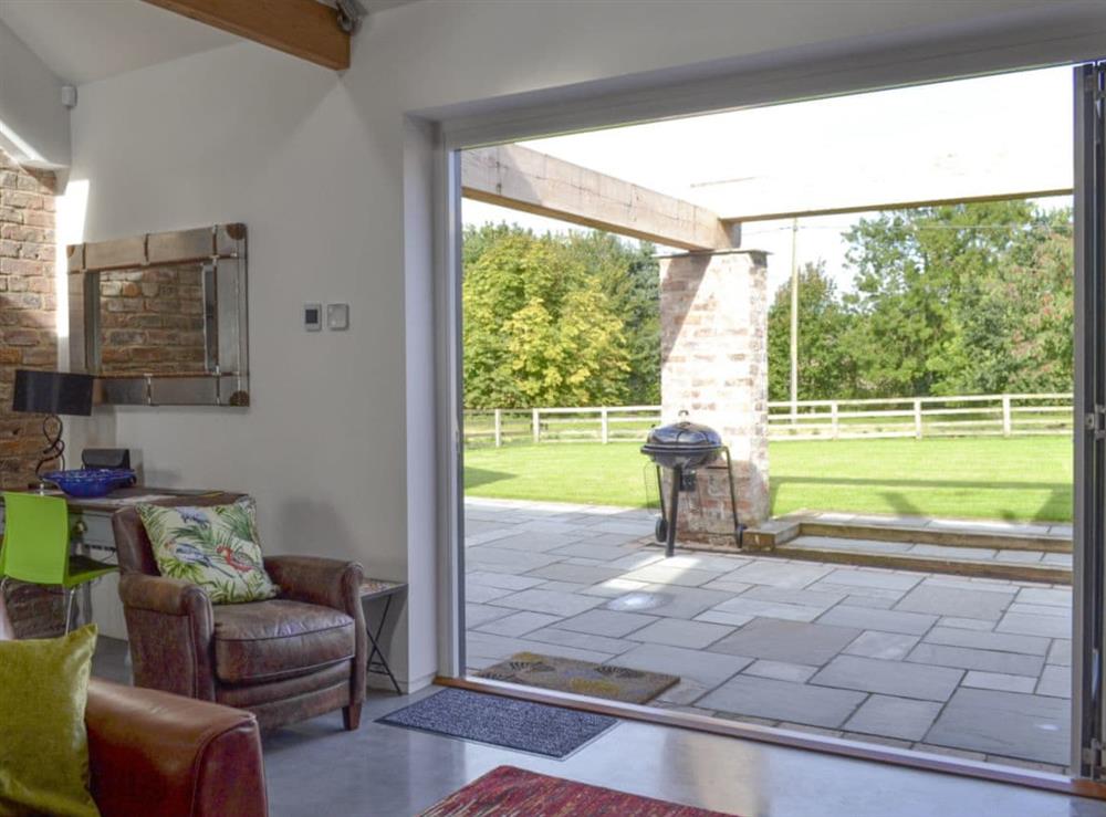 Bi-fold doors from living area to patio at Bluebell Barn in Dunnington, near York, North Yorkshire