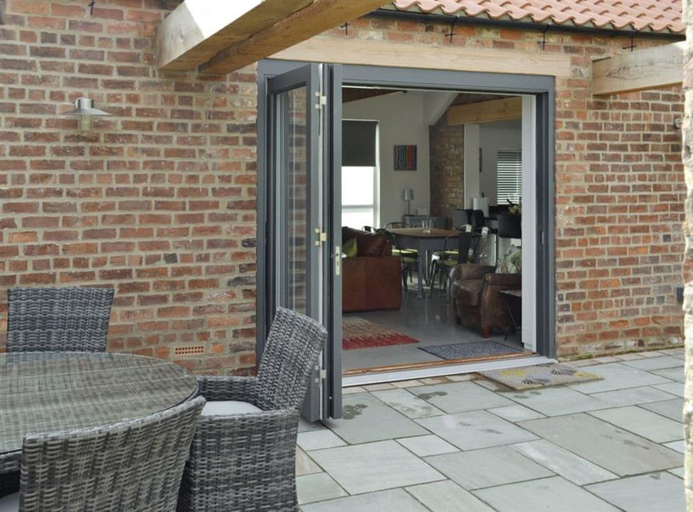 Bi-fold doors from patio to living area at Bluebell Barn in Dunnington, near York, North Yorkshire