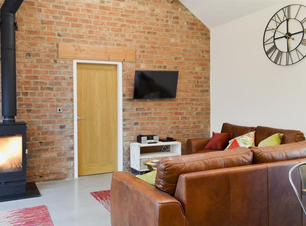 Bright and cosy living area with wood burener at Bluebell Barn in Dunnington, near York, North Yorkshire