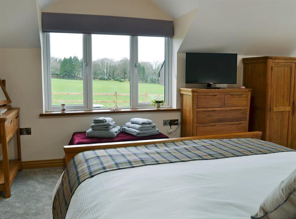 Romantic galleried with bedroom kingsize bed (photo 2) at Bluebell Barn in Okehampton, Devon
