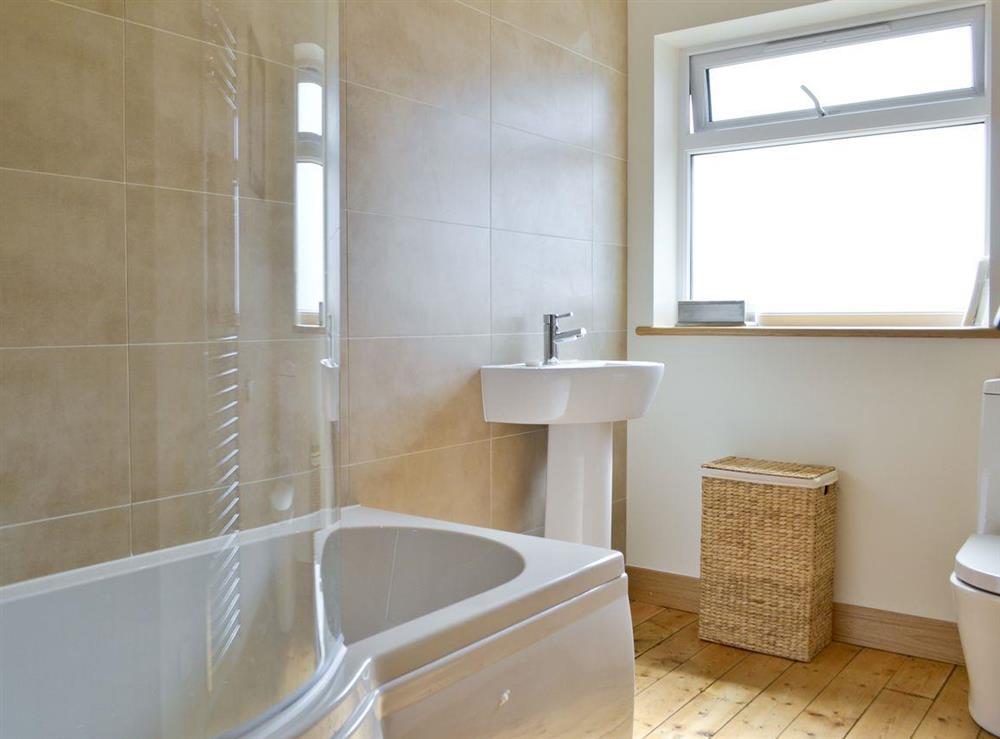 Family bathroom with shower over bath at Bluebell Cottage in Burton in Lonsdale, near Ingleton, North Yorkshire