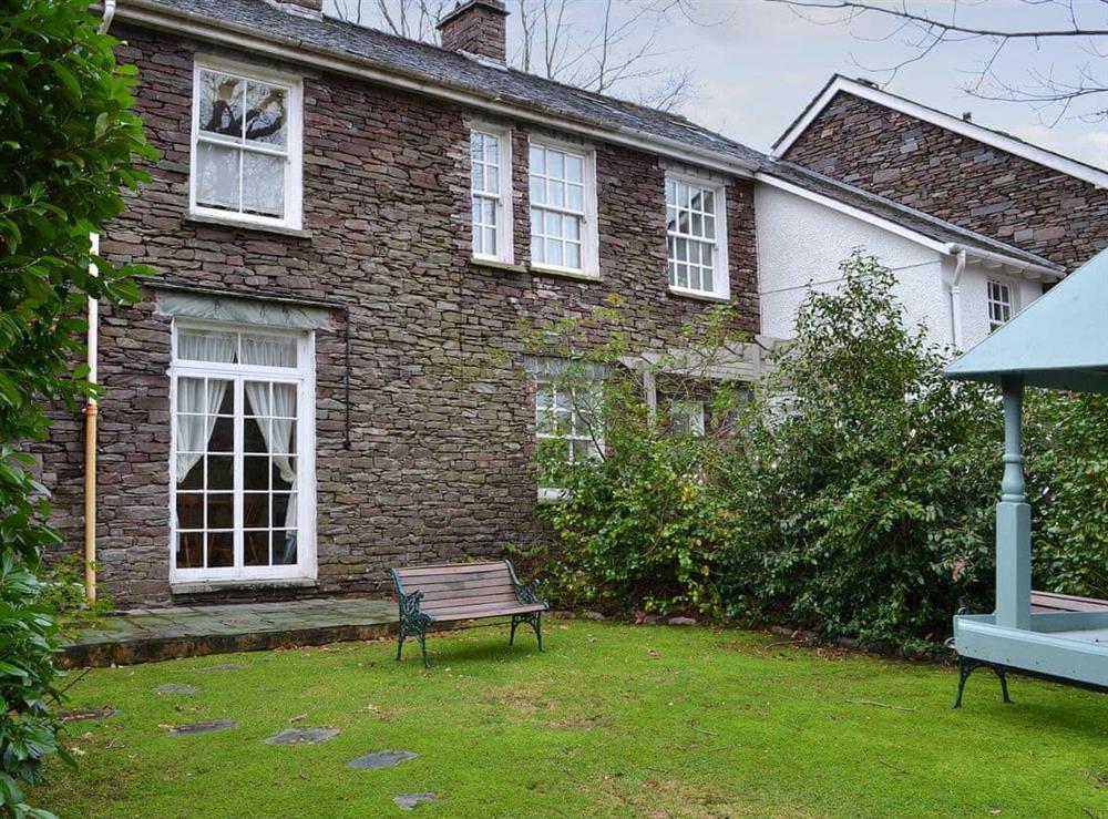 Private garden with bench seating at Bluebell Cottage in Grasmere, near Ambleside, Cumbria