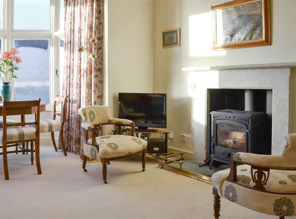Welcoming living room with wood burner at Bluebell Cottage in Grasmere, near Ambleside, Cumbria