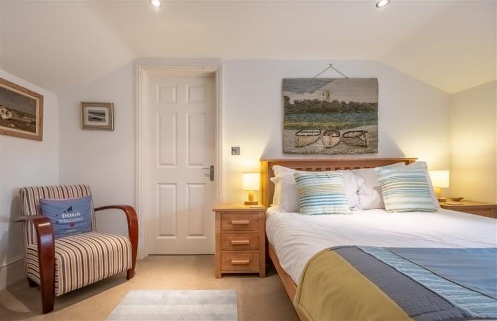 Master bedroom with door to dressing room and en-suite shower at Bluebell Cottage, Little Walsingham