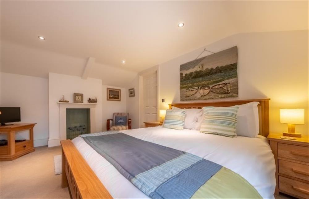 Master bedroom with ornamental fireplace and Smart television at Bluebell Cottage, Little Walsingham