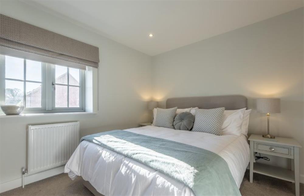 First floor: Bedroom two with king-size bed (photo 2) at Bluebell Cottage, Thornham near Hunstanton