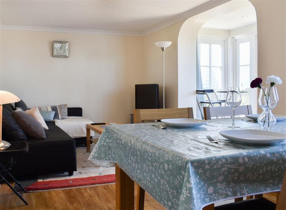 Living area and wooden-floored dining area at Bluebell Cottage in Whitstable, Kent