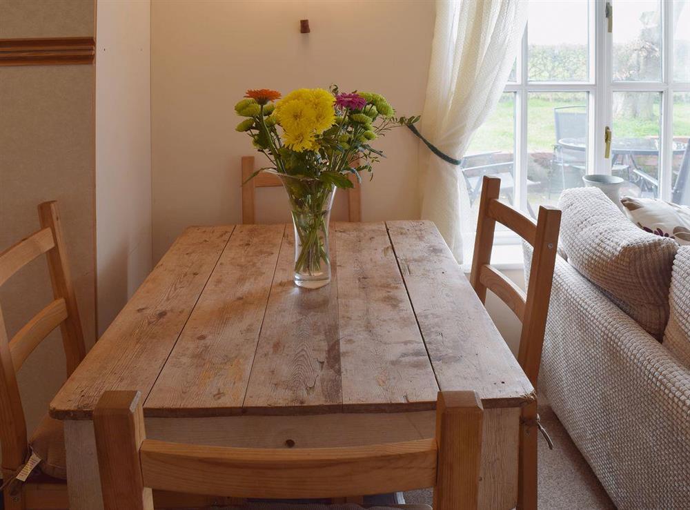 A farmhouse kitchen style dining table between the living and kitchen area has great views over the countryside at Blueberry Cottage in Debenham, near Framlingham, Suffolk