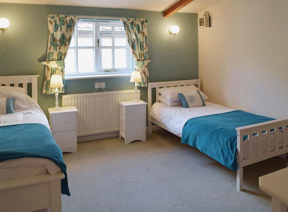 Original features such as exposed beams feature in the twin bedroom at Blueberry Cottage in Debenham, near Framlingham, Suffolk