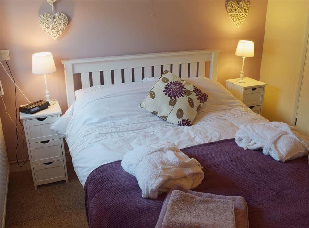 The romantic decor of the double bedroom is complemented by the en-suite wc at Blueberry Cottage in Debenham, near Framlingham, Suffolk
