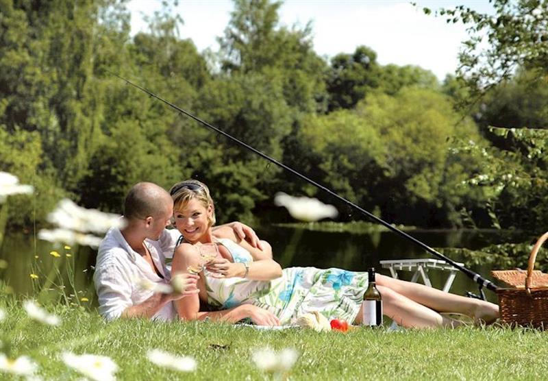 Fishing at Lyneham Lake adjcent to park at Bluewood Lodges in Oxfordshire, Heart of England