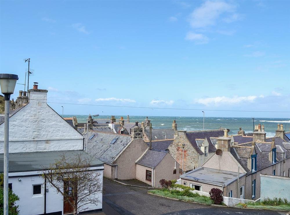 View over the rooftops to the sea beyond at Boatmans Cottage in Portessie, near Buckie, Banffshire