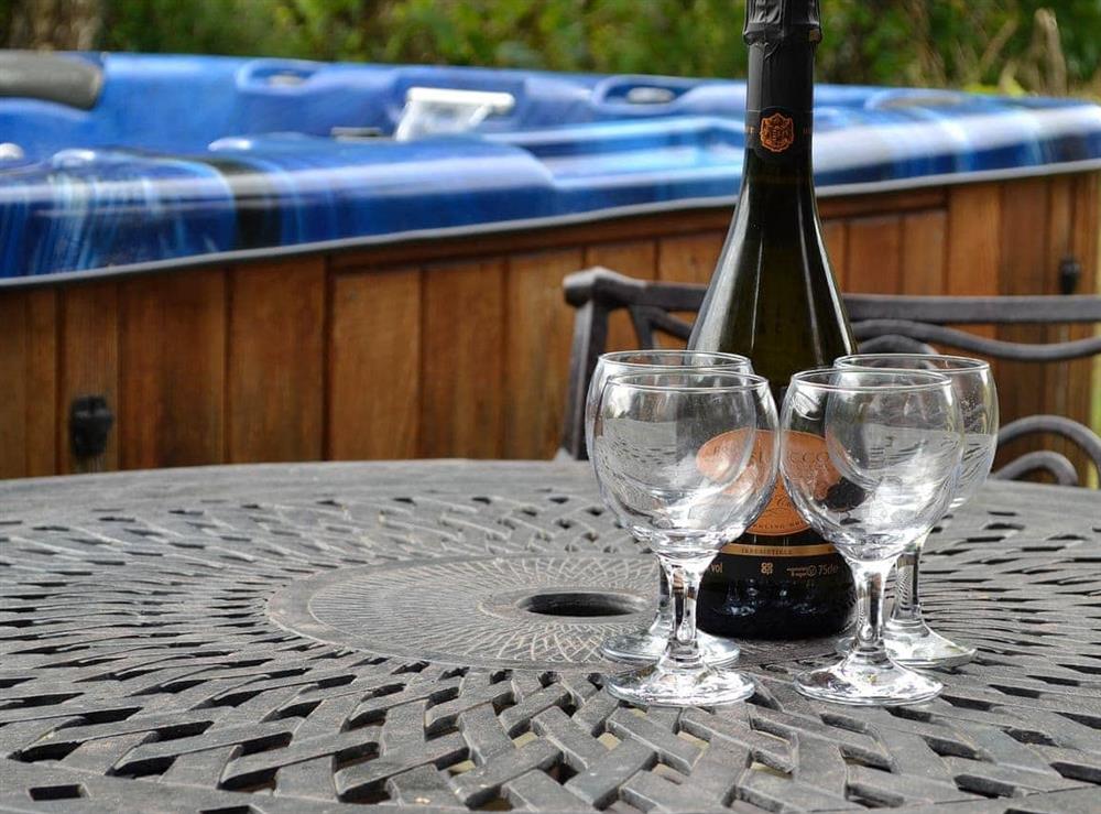 Relax and enjoy a drink by the hot tub at Edw Lodge, 