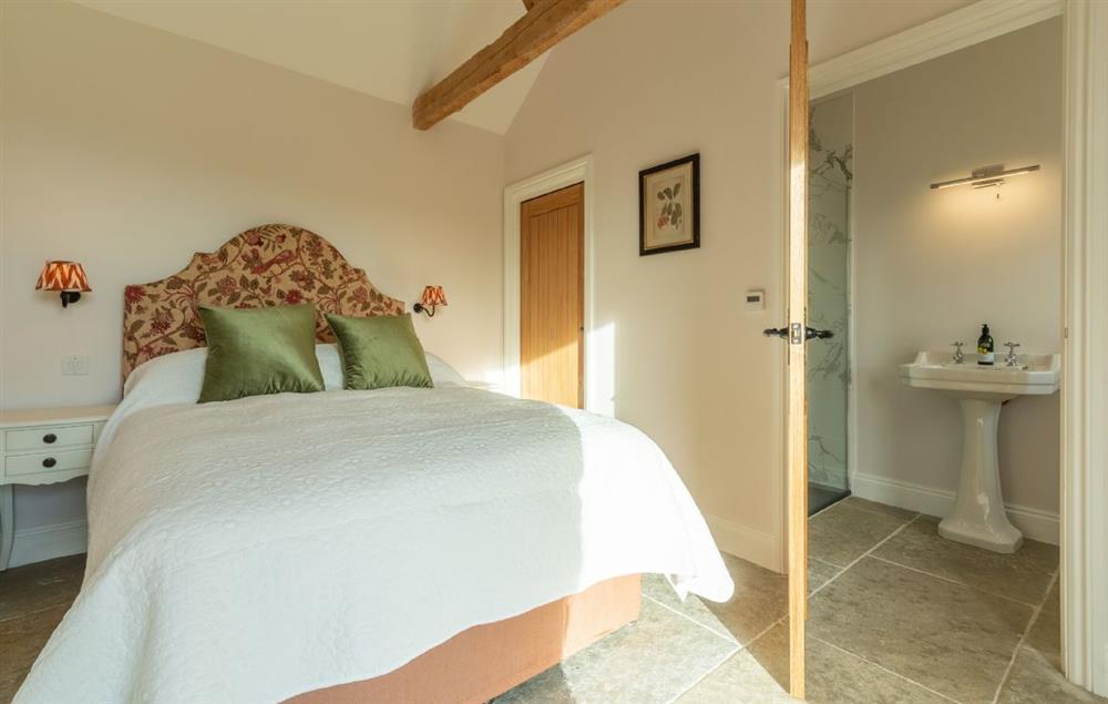 Bedroom with 4’6 double bed and en-suite shower room at Bodney Lodge, Bodney