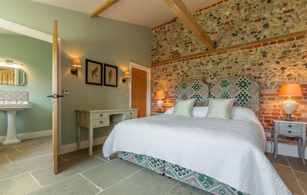 Bedroom with 6’ super king size zip and link bed and en-suite bathroom at Bodney Lodge, Bodney