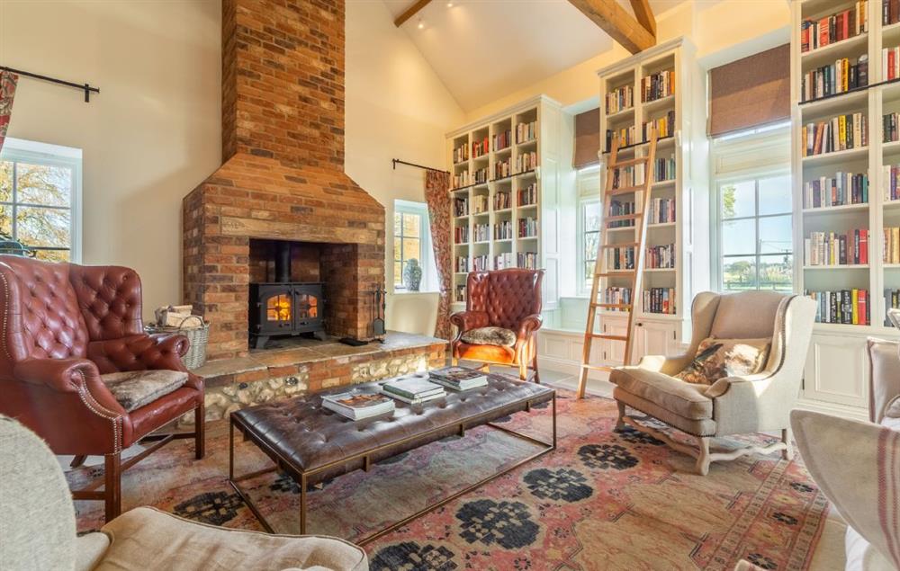Comfortable sitting room with wood burning stove and exposed beams