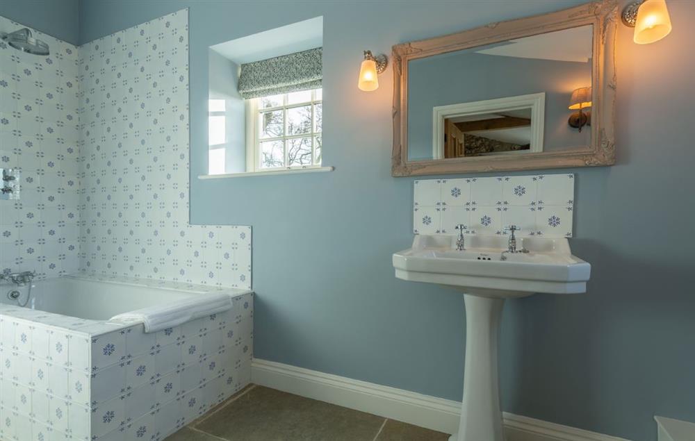 En-suite bathroom with bath and shower over (photo 2) at Bodney Lodge, Bodney
