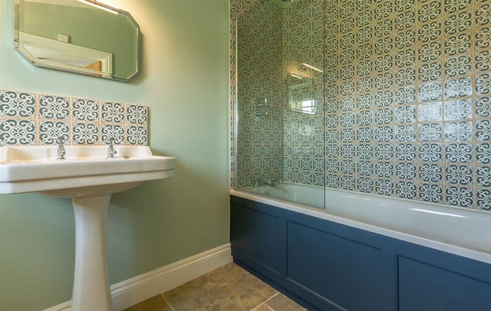 En-suite bathroom with bath and shower over at Bodney Lodge, Bodney