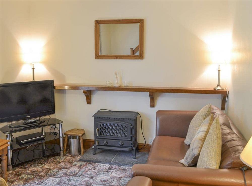 Welcoming living room with wood burner at Bodwi Isaf in near Abersoch, Gwynedd