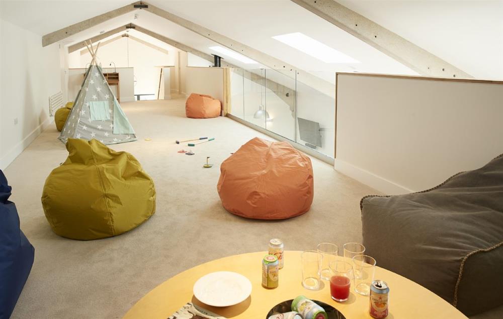 large, open-plan area for relaxation, with bean bags and projector screen