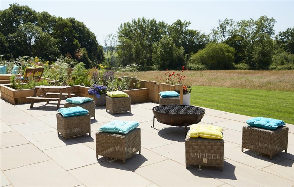 On the terrace is plenty of ratten furniture as well as a fire pit and barbecue (photo 2) at Bokes Barn, Hawkhurst