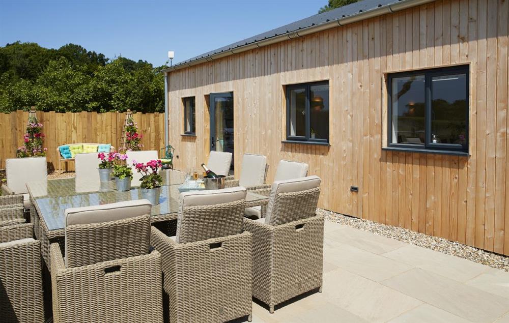 On the terrace is plenty of ratten furniture as well as a fire pit and barbecue at Bokes Barn, Hawkhurst