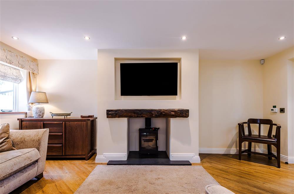 The spacious sitting room enjoys a wood burning stove