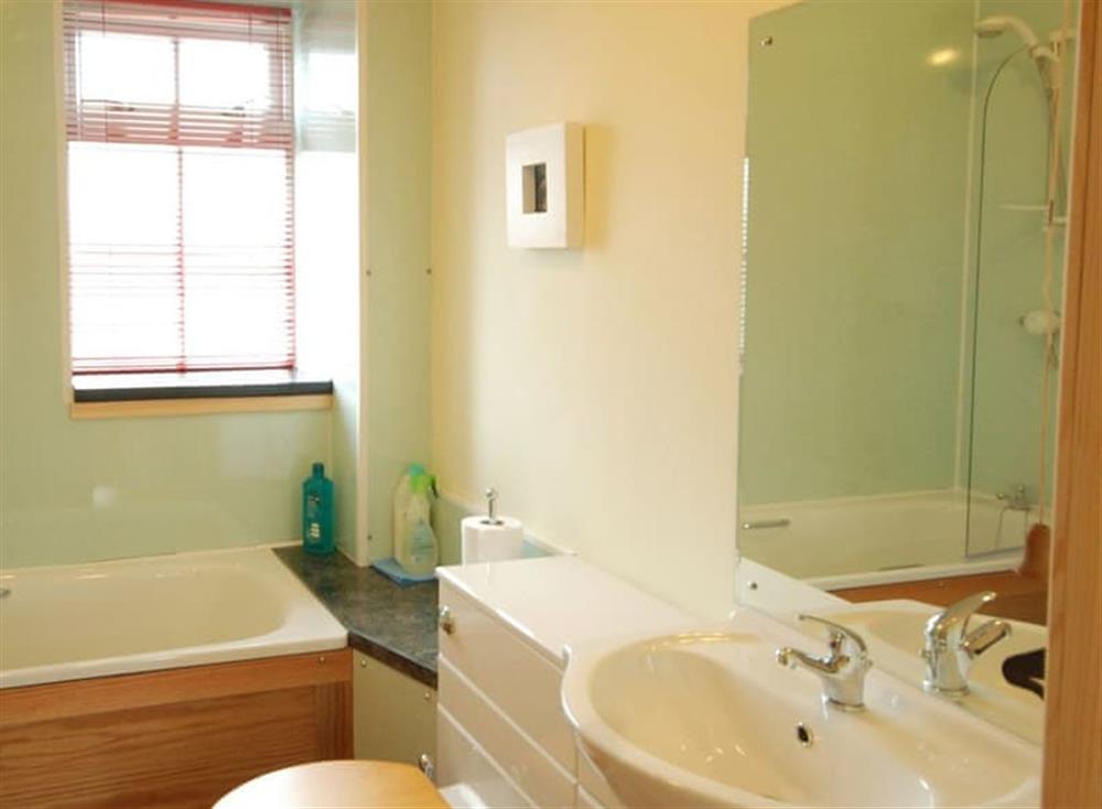 Family bathroom with shower over bath at Clematis Cottage, 