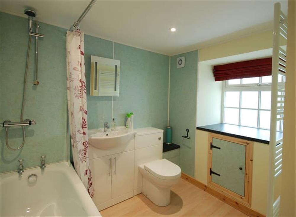 Family bathroom with shower over bath at Garden Cottage, 