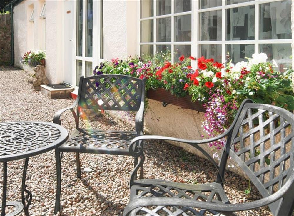 Gravelled patio area with outdoor furniture at Rose Cottage, 
