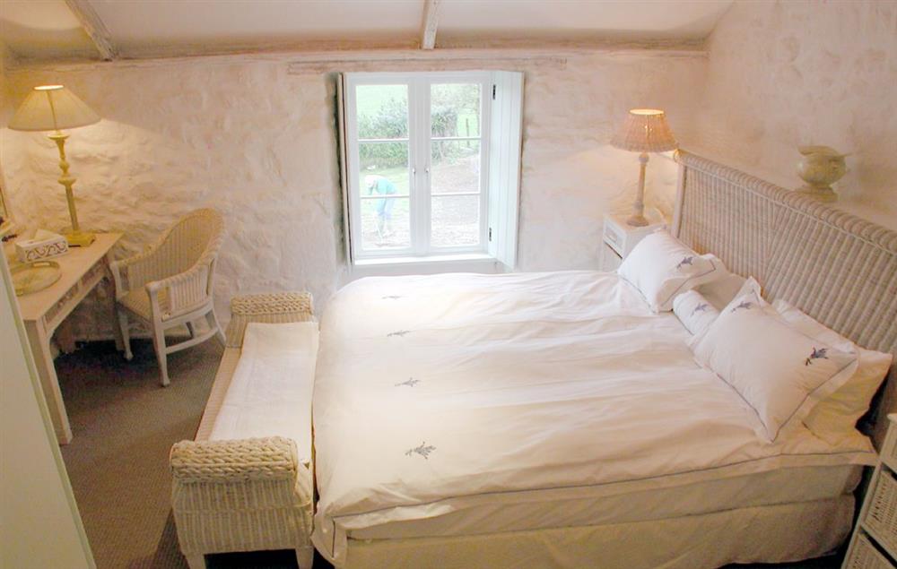 Double bedroom with 6’ super-king bed and bathroom opposite with bath and shower over at Bonython Farmhouse, Helston