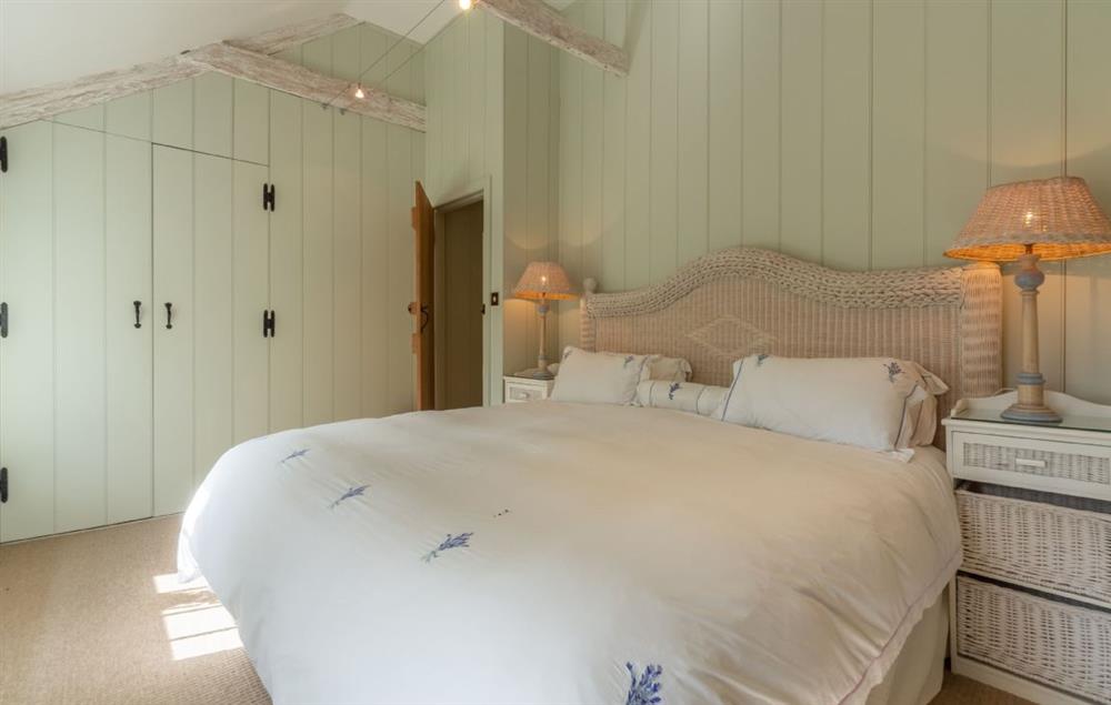Double bedroom with 6’ super-king bed and en-suite shower room at Bonython Farmhouse, Helston